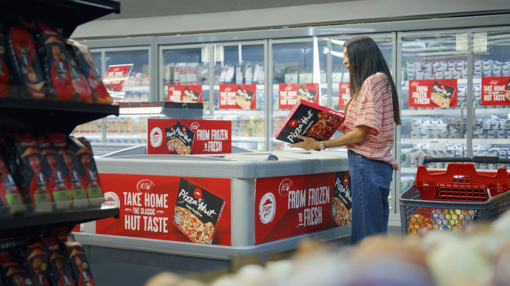 User looking at the box of frozen pizza